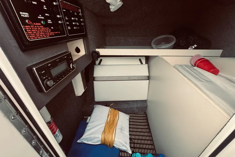  Yacht Photos Pics Interior of a 2019 Formula 310 FX Bowrider boat cabin with control panel and storage.