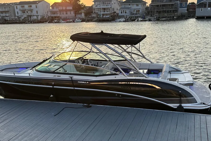  Yacht Photos Pics 2019 Formula 310 FX Bowrider docked at sunset, waterfront homes in background.