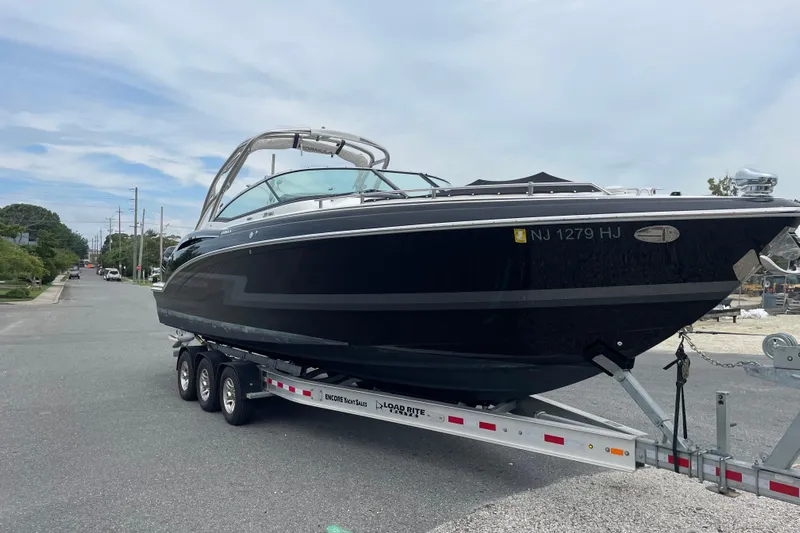  Yacht Photos Pics 2019 Formula 310 FX Bowrider on trailer, parked on a street, side view.