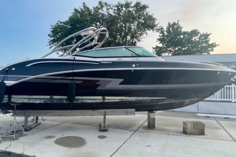  Yacht Photos Pics 2019 Formula 310 FX Bowrider boat on stands, sleek black design.