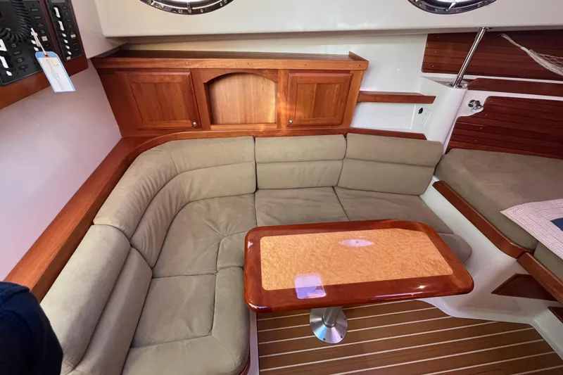 Galene Yacht Photos Pics 2010 Back Cove 33 Express Hardtop interior with beige seating and wooden table.