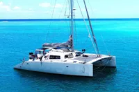 Catamaran Flash Cat 52S, 2015 model, sailing on clear blue ocean waters.