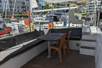 Spacious deck of 2015 Flash Cat 52S yacht with seating and table in marina.