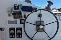 Helm of 2015 Flash Cat 52S yacht with steering wheel and navigation instruments.