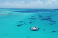 Catamaran Flash Cat 52S (2015) sailing in clear turquoise waters under a blue sky.