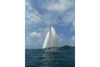 Sailing catamaran Flash Cat 52S (2015) on open sea under blue sky.