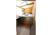Cozy cabin interior of 2015 Flash Cat 52S yacht with bed and storage.