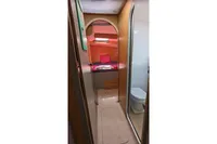Interior of 2015 Flash Cat 52S yacht, featuring cozy cabin and compact bathroom.