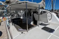 2015 Flash Cat 52S yacht with spacious deck and seating area in marina.