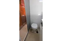 Bathroom interior of 2015 Flash Cat 52S yacht, featuring a compact toilet and modern design.