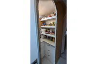 Pantry shelves stocked with food items inside a 2015 Flash Cat 52S yacht.