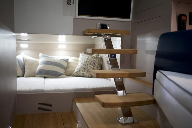  Yacht Photos Pics Luxurious interior of 2022 SACS 47 Rebel yacht with modern staircase and cozy seating area.