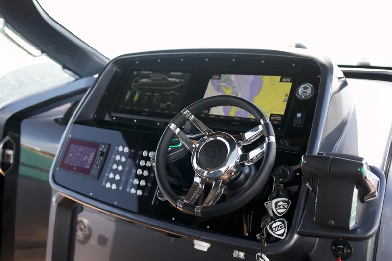  Yacht Photos Pics 2022 SACS 47 Rebel boat dashboard with advanced navigation system and steering wheel.