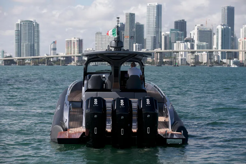  Yacht Photos Pics 2022 SACS 47 Rebel boat on water with city skyline in background.