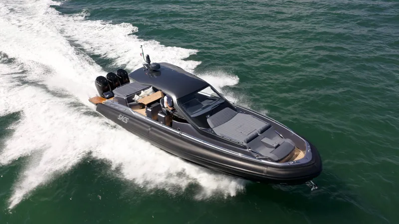  Yacht Photos Pics 2022 SACS 47 Rebel speedboat cruising on open water.