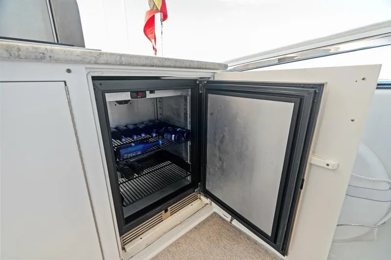 Yes Yacht Photos Pics Open mini fridge on 2011 Westport yacht, stocked with beverages, under a countertop.
