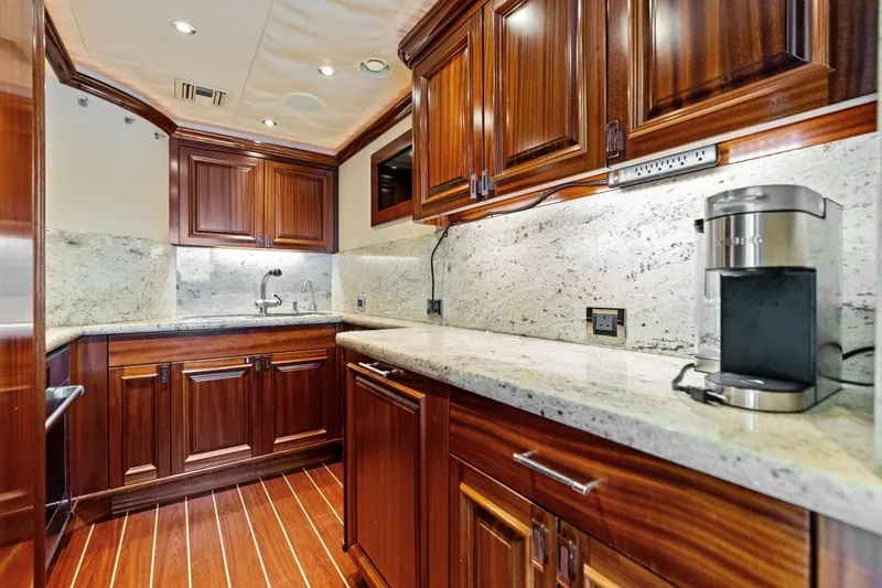 Yes Yacht Photos Pics Luxurious yacht kitchen with wooden cabinetry, granite countertops, and modern appliances, Westport 2011 model.