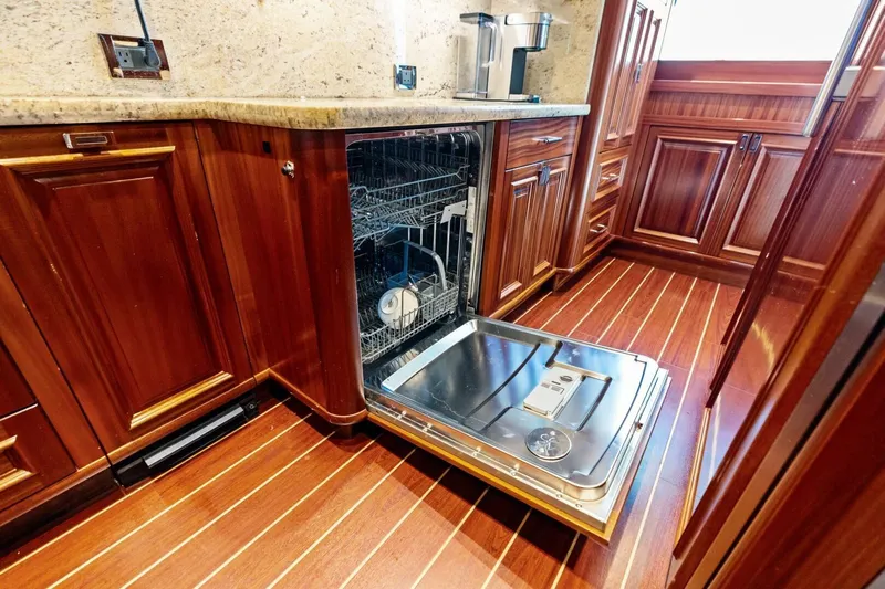 Yes Yacht Photos Pics Luxurious yacht kitchen with open dishwasher, wooden cabinets, and sleek countertops, Westport 2011 model.