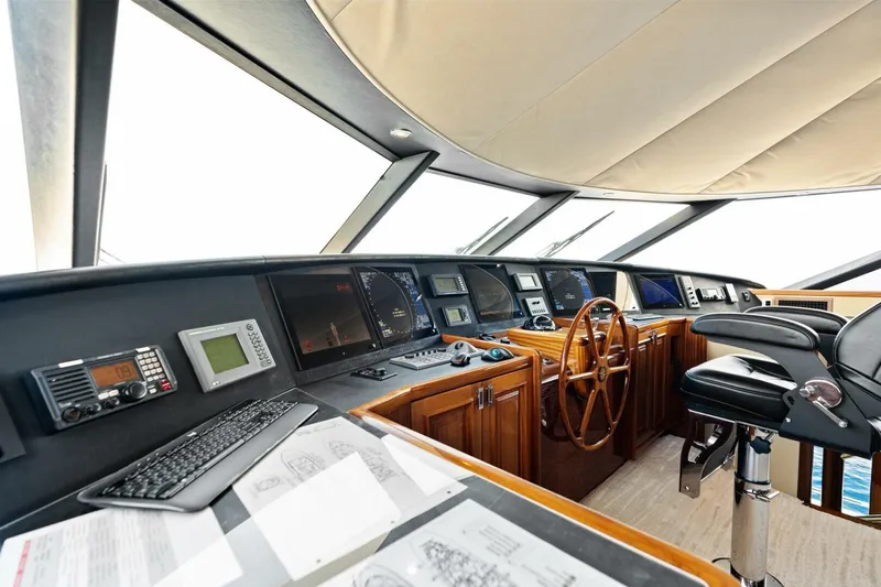 Yes Yacht Photos Pics Luxurious 2011 Westport yacht helm with advanced navigation equipment and elegant wooden steering wheel.