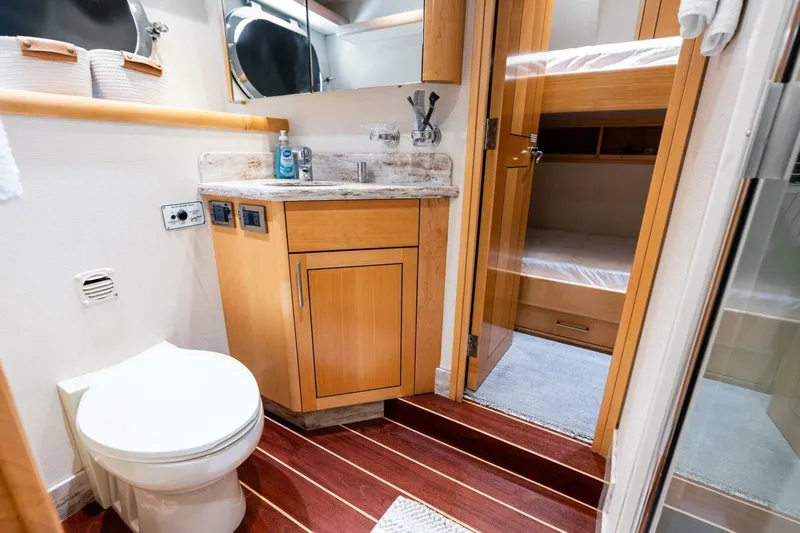 Yes Yacht Photos Pics Luxurious 2011 Westport yacht bathroom with wooden cabinetry and bunk bed view.