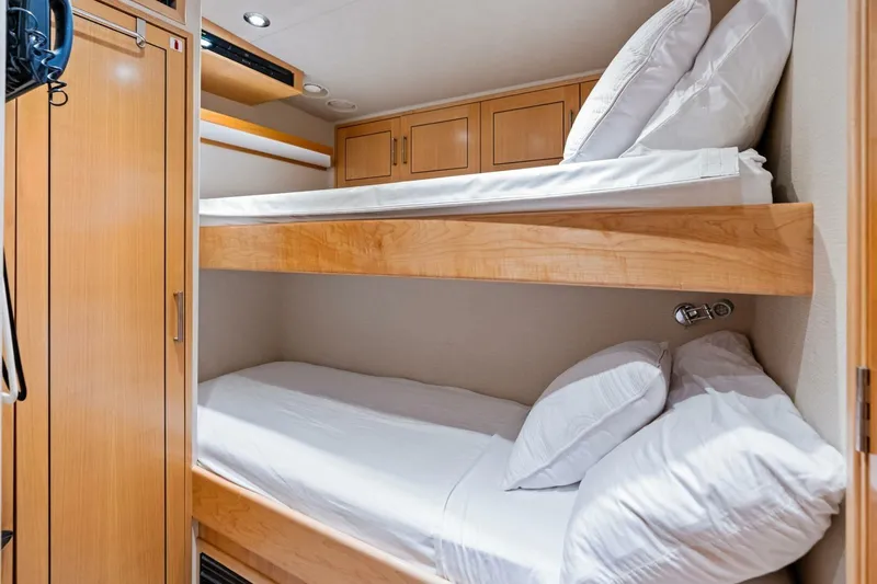 Yes Yacht Photos Pics Bunk beds in a 2011 Westport yacht cabin with wooden cabinetry and white bedding.