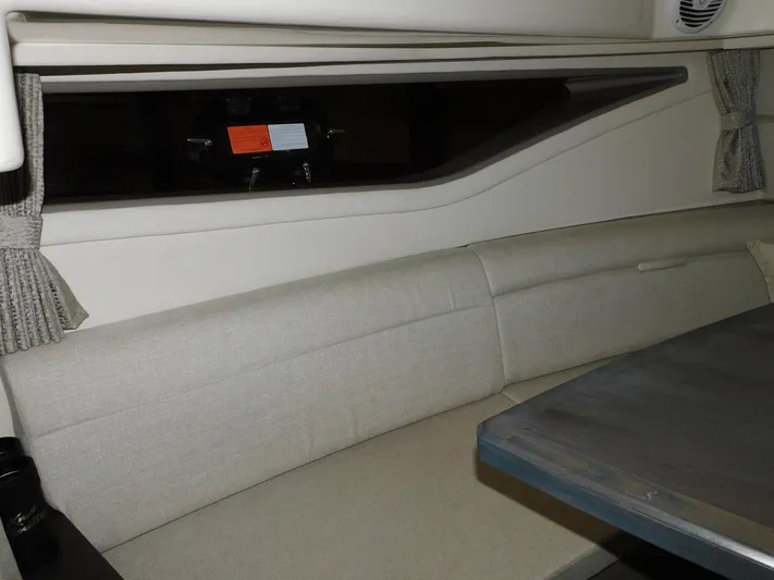 Not Guilty Yacht Photos Pics Interior seating area of 2018 Sea Ray Sundancer yacht with window and table.