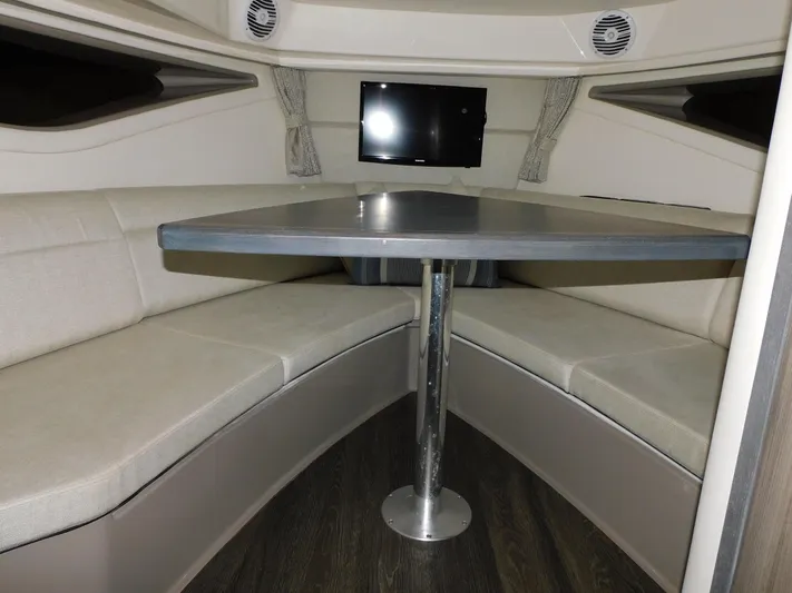 Not Guilty Yacht Photos Pics 2018 Sea Ray Sundancer cabin with U-shaped seating and mounted TV.