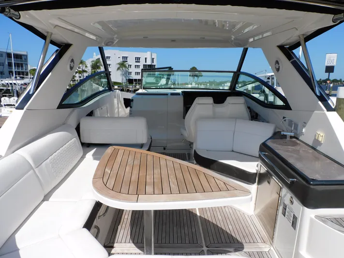 Not Guilty Yacht Photos Pics 2018 Sea Ray Sundancer yacht interior with white seating and wooden table.