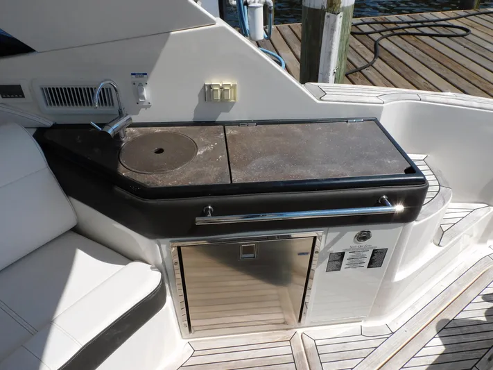 Not Guilty Yacht Photos Pics 2018 Sea Ray Sundancer boat kitchenette with sink and mini-fridge.
