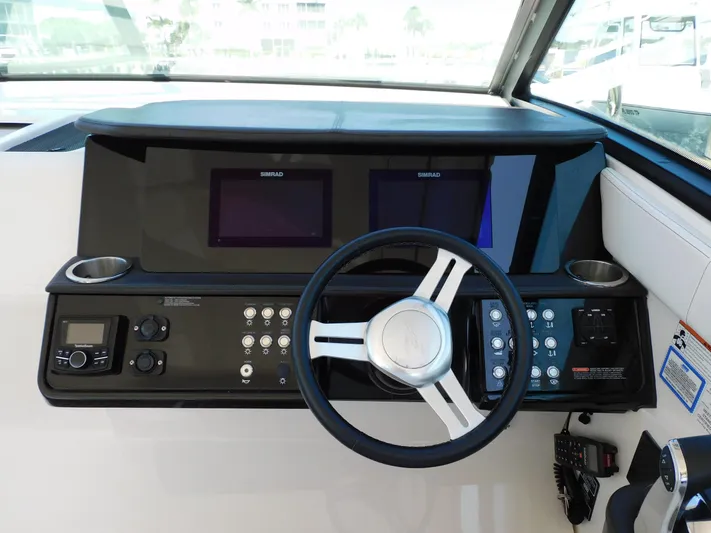 Not Guilty Yacht Photos Pics 2018 Sea Ray Sundancer helm with dual Simrad displays and modern controls.