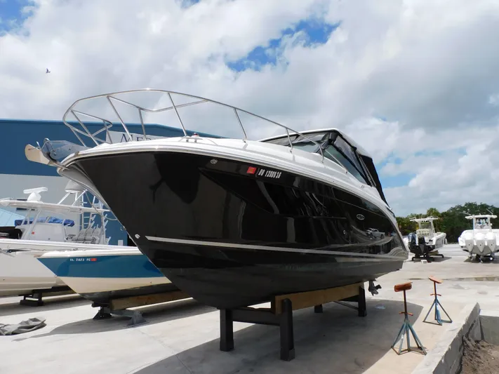 Not Guilty Yacht Photos Pics 2018 Sea Ray Sundancer boat on dry dock under a cloudy sky.