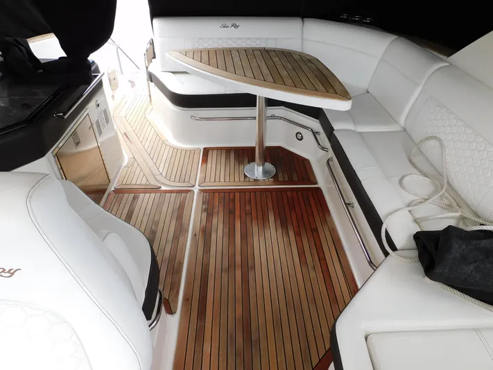 Not Guilty Yacht Photos Pics 2018 Sea Ray Sundancer interior with white seating and wooden table.