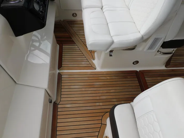 Not Guilty Yacht Photos Pics 2018 Sea Ray Sundancer interior with white leather seats and teak flooring.