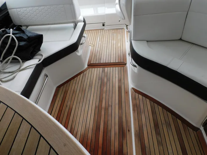 Not Guilty Yacht Photos Pics 2018 Sea Ray Sundancer boat interior with teak flooring and white cushioned seating.