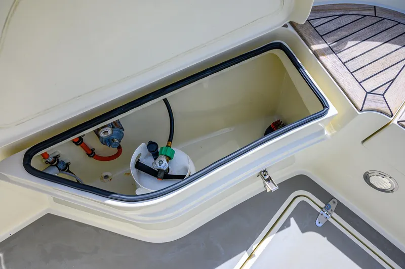  Yacht Photos Pics Open storage compartment on 2019 Targa 27.2 boat deck, showing equipment and fittings.