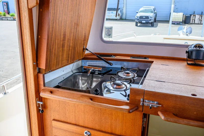  Yacht Photos Pics Compact kitchen area on 2019 Targa 27.2 boat with stove and sink.