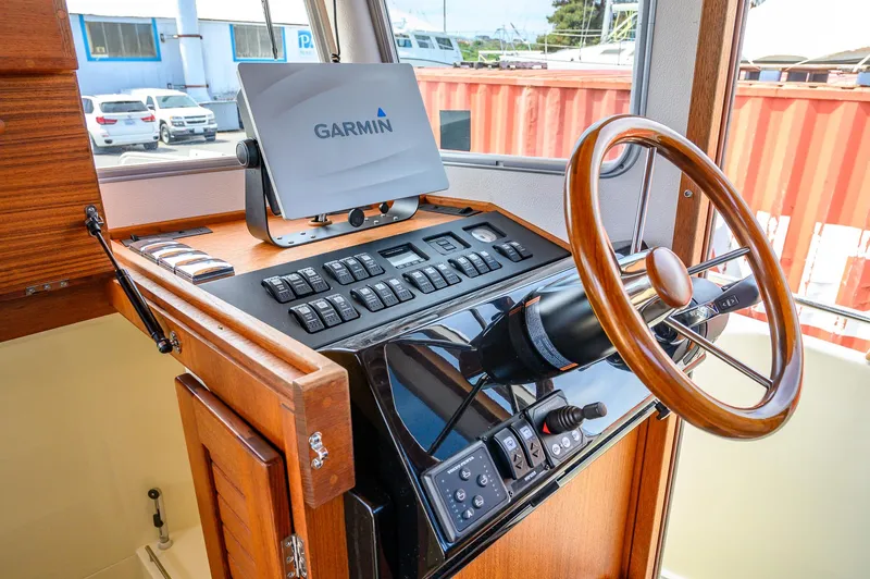  Yacht Photos Pics 2019 Targa 27.2 boat helm with Garmin navigation system and wooden steering wheel.