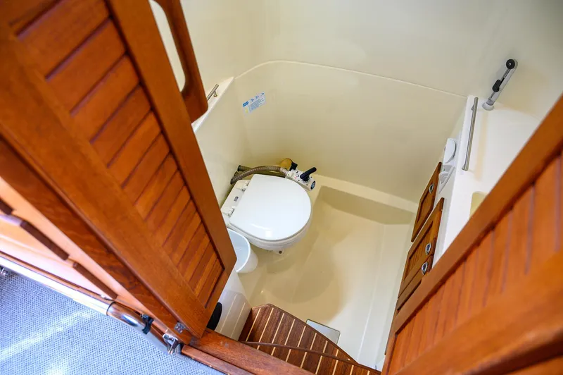  Yacht Photos Pics Compact bathroom in 2019 Targa 27.2 boat with wooden doors and marine toilet.