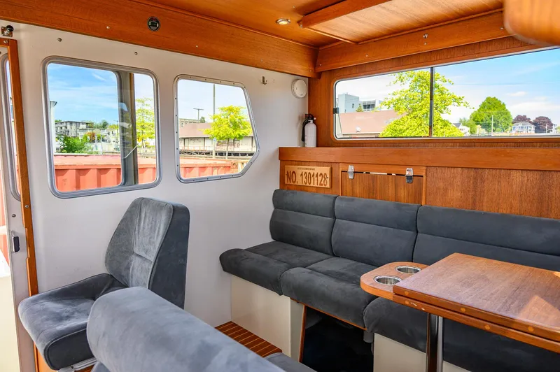  Yacht Photos Pics Interior of 2019 Targa 27.2 boat with gray seating and wooden accents.