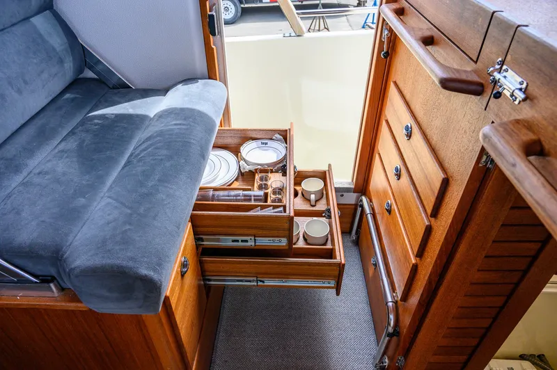  Yacht Photos Pics Interior of 2019 Targa 27.2 boat with open wooden drawers and seating area.