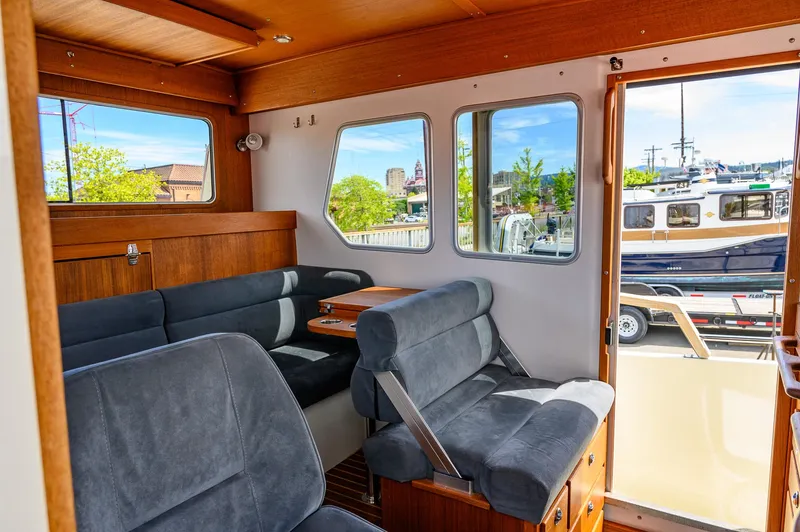  Yacht Photos Pics Interior of 2019 Targa 27.2 boat with plush seating and wooden accents.