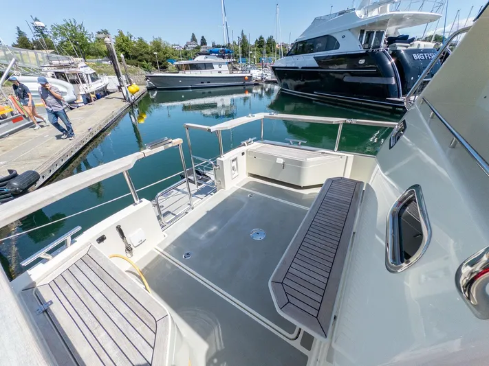  Yacht Photos Pics 2019 Targa 27.2 boat docked at marina, featuring spacious deck and seating area.