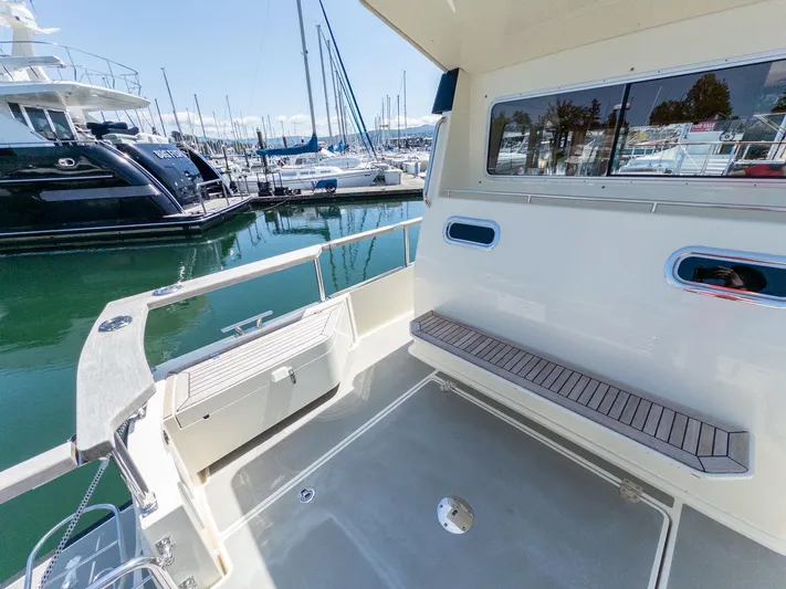  Yacht Photos Pics 2019 Targa 27.2 boat interior with seating, docked at marina.