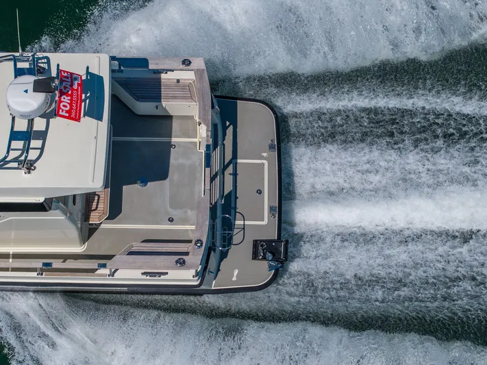  Yacht Photos Pics Aerial view of 2019 Targa 27.2 boat cruising with "For Sale" sign.