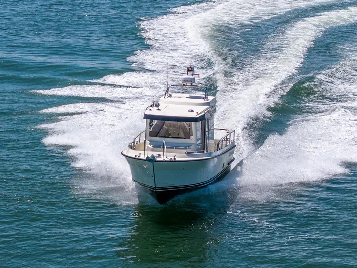  Yacht Photos Pics 2019 Targa 27.2 boat cruising on open water, creating a dynamic wake.