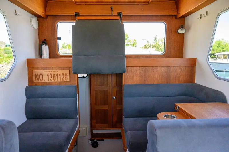  Yacht Photos Pics Interior of 2019 Targa 27.2 boat with wooden accents and gray seating.