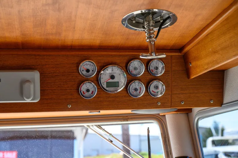  Yacht Photos Pics Dashboard of 2019 Targa 27.2 boat with gauges and wooden paneling.