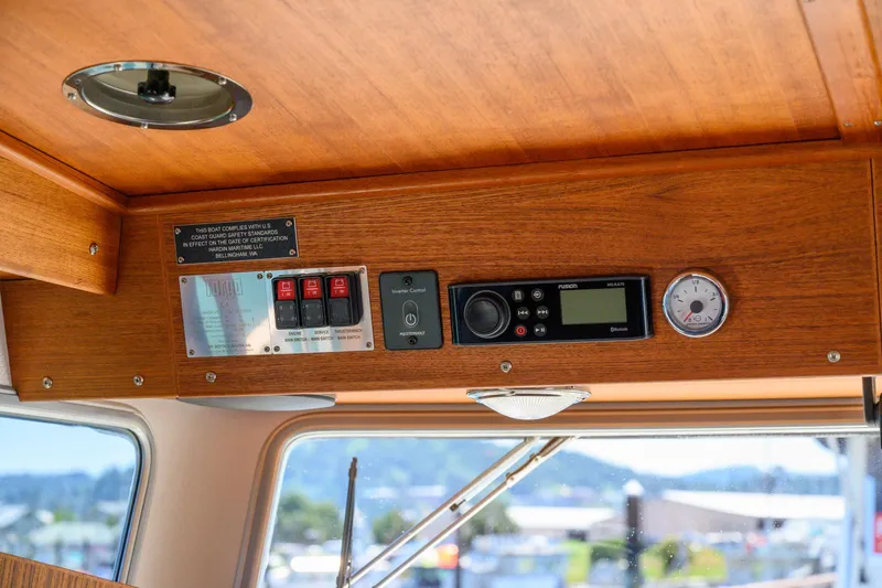  Yacht Photos Pics Control panel of a 2019 Targa 27.2 boat with wooden interior and electronic gauges.