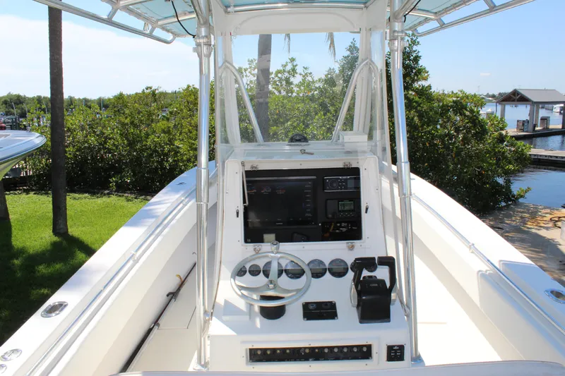  Yacht Photos Pics 2002 Contender 31 CC boat console with steering wheel and navigation equipment.
