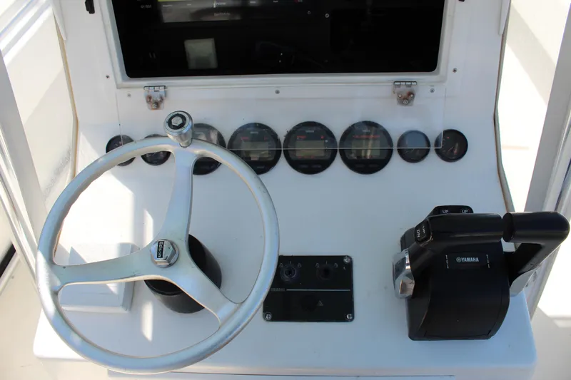  Yacht Photos Pics Steering console of a 2002 Contender 31 CC boat with Yamaha controls.